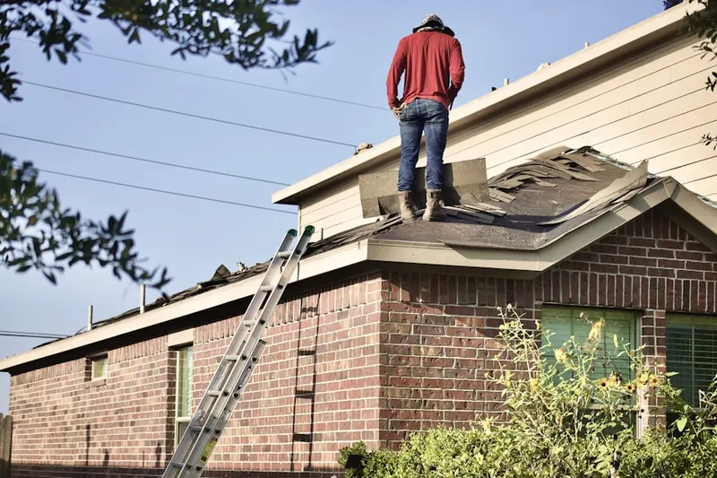 Professional roofer working on a residential roof in Camp Croft